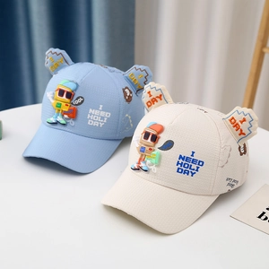 Detailed view of kids' cartoon baseball caps with 3D robot patches and breathable mesh