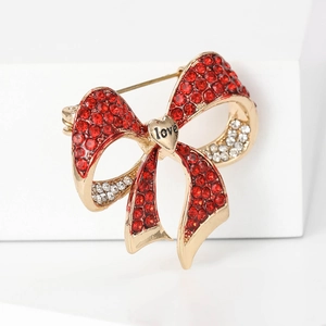 Elegant gold bow brooch with sparkling red and clear rhinestones and love heart detail