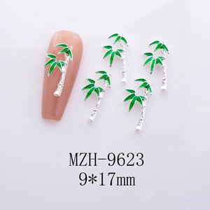 Detail shot of green bamboo nail charms with silver metal base and 9x17mm size specs