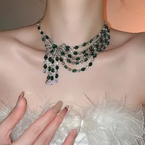 Sparkling zircon bow tassel necklace with emerald green stones and layered silver fringes