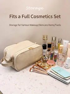 Large capacity cream PU leather makeup bag with double zippers and gold hardware