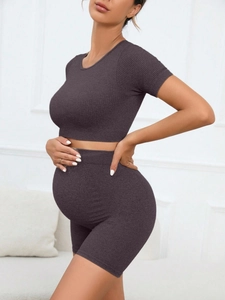 Detail of grey ribbed seamless maternity activewear set with belly support shorts