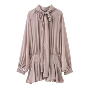 Elegant dusty pink long-sleeve blouse with tie-neck bow and ruffled hem on white background