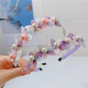 Detail shot of mesh flowers and artificial pearls on elegant fabric headbands