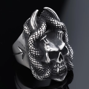Close-up of gothic stainless steel ring with skull snake and devil horn motifs