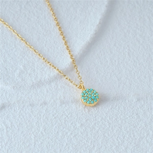Detailed macro view of the gold-plated S925 sterling silver chain with turquoise moon pendant
