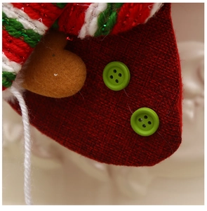 Detail showing texture of burlap, felt heart patch, and buttons on Christmas stocking