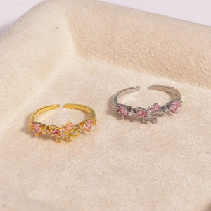Macro shot of adjustable pink gemstone bow rings in gold and silver plating