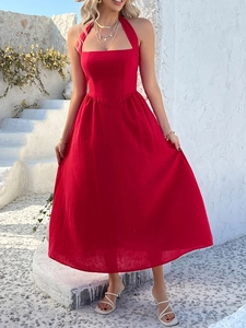 Detail of red halter neck maxi dress featuring a high waist and airy linen fabric
