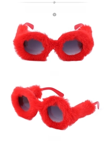 Macro view of round plush-covered red sunglasses frame with fluffy faux fur texture