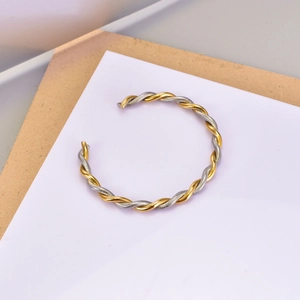 Detailed view of bicolor twisted rope bangle with gold and silver stainless steel finish