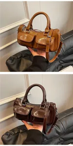 Detail of vintage high-gloss leather saddle bags with dual front pockets and straps