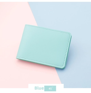Close-up of mint blue faux leather card holder with fine texture and neat stitching