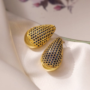 Luxurious 18K gold-plated teardrop stud earrings with pavé blue zircons on beige silk