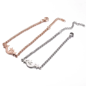 Detailed view of moon and star charms on gold and silver plated link bracelets