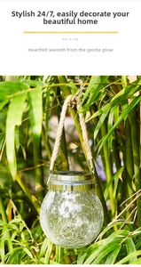 Solar crackle glass jar light hanging by hemp rope in a natural bamboo garden setting