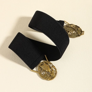 Elastic black waist belt with gold hollow crane buckle on a beige background
