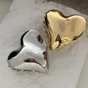 Elegant gold and silver heart-shaped metal hair claws with glossy metallic finish