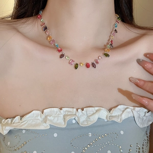 Macro shot of colorful cubic zirconia necklace on a model showing geometric pendant detail