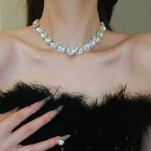 Close-up of luxury round diamond flower necklace worn on neck to show elegant fit