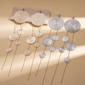 Exaggerated metal long tassel earrings in gold and silver with textured round discs