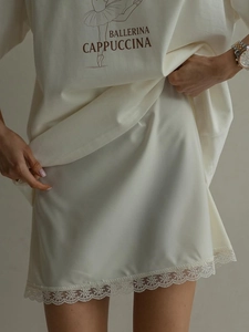 Lace trim satin slip skirt in cream white paired with a printed tee for layered summer style