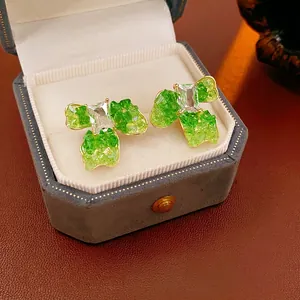 Green clover flower earrings with gold plating and zircon studs in a luxury jewelry box
