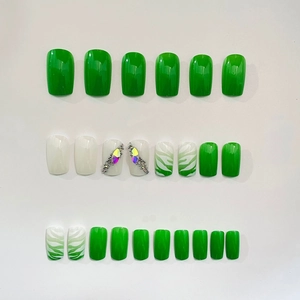 Short square press-on nails set with emerald green zebra patterns and sparkling crystals