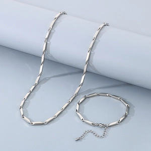 Detailed view of silver stainless steel geometric link necklace and bracelet set