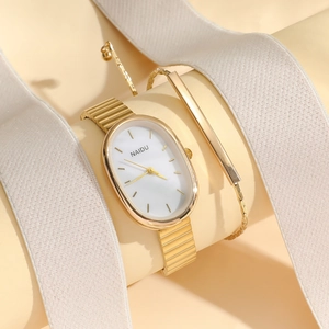 Detailed view of an elegant oval gold quartz watch and matching bracelet on a display stand