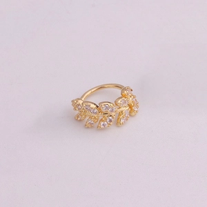 Detailed view of gold leaf cartilage earring with micro-set sparkling zircon stones