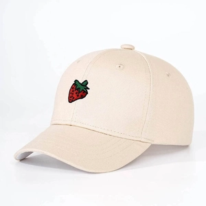Close-up of strawberry embroidery detail on cotton baseball cap for kids