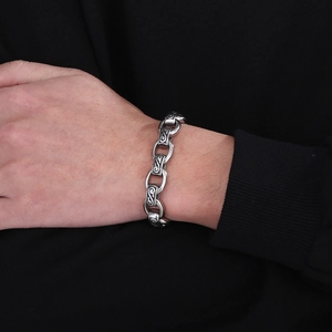 Macro detail of 12mm punk retro steel chain bracelet with intricate vintage patterns