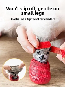 Detail of waterproof dog socks showing non-slip red sole and adjustable magic strap