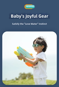 Detail of a large 1200ml mint green water gun held by a boy on a sunny lawn