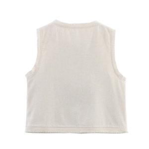 Detailed close-up of sleeveless linen vest with raw fringe edges and textured fabric