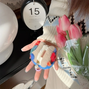Detail of plush bucket coin purse with pearl charm pendant and zip closure