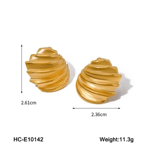 Detail view of gold shell earrings with dimensions 2.61cm by 2.36cm and spiral texture