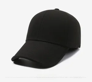 Close-up of a black winter baseball cap with side metal brand plaque and twill texture