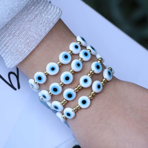 Evil Eye beaded bracelet with white resin beads and gold metal accents for women's jewelry
