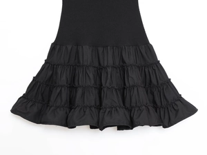Detail of black multi-layered ruffle hem with knit and woven fabric patchwork texture