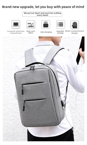 Detail of grey business laptop backpack featuring a built-in USB charging port and multi-layers