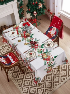 Vista detallada del mantel navideño festivo y las fundas de silla de Papá Noel de gala