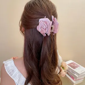 Elegante pinza per capelli con rosa in raso color malva indossata per acconciature