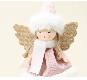 Detailed view of plush Christmas angel doll with pink knit hat and golden glitter wings