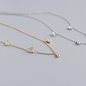Macro shot of minimalist S925 sterling silver necklaces with sparkling cubic zirconia charms