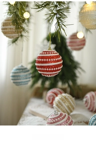 Detail of red and white striped Christmas ball with sequins and faux pearl decorations