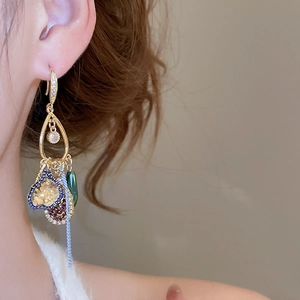 Detail of vintage bohemian dangle earring with crystal fringes and colorful beads