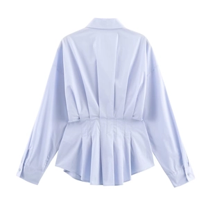 Detail view showing the pleated waist design on the back of this light blue cotton shirt