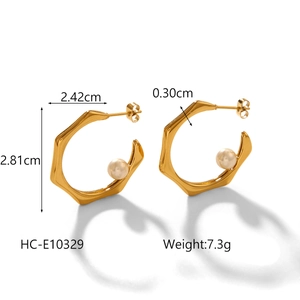 Detail view of irregular 18K gold-plated C-shaped steel earrings with pearl accents